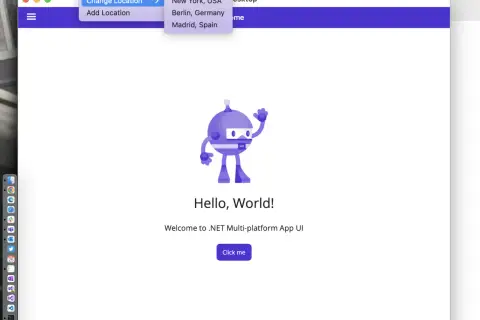 Aplikacja .NET MAUI z menu "Zmień lokalizację" otwartym, pokazującym opcje Nowy Jork, Berlin i Madryt.